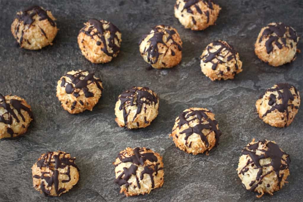 Macaroons on a dark grey surface.