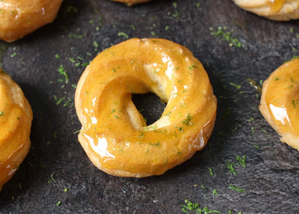 Close up on one glazed donut with lime zest