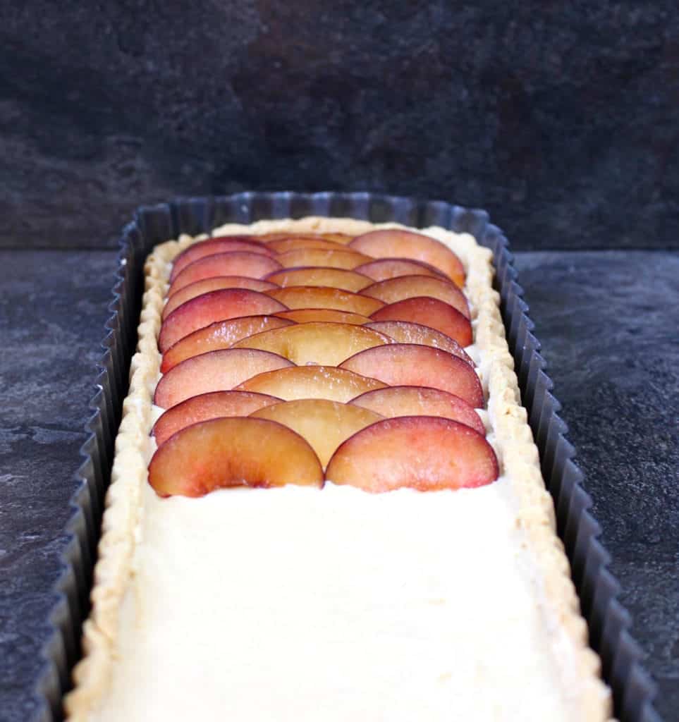 Half of the plums placed over the pastry cream