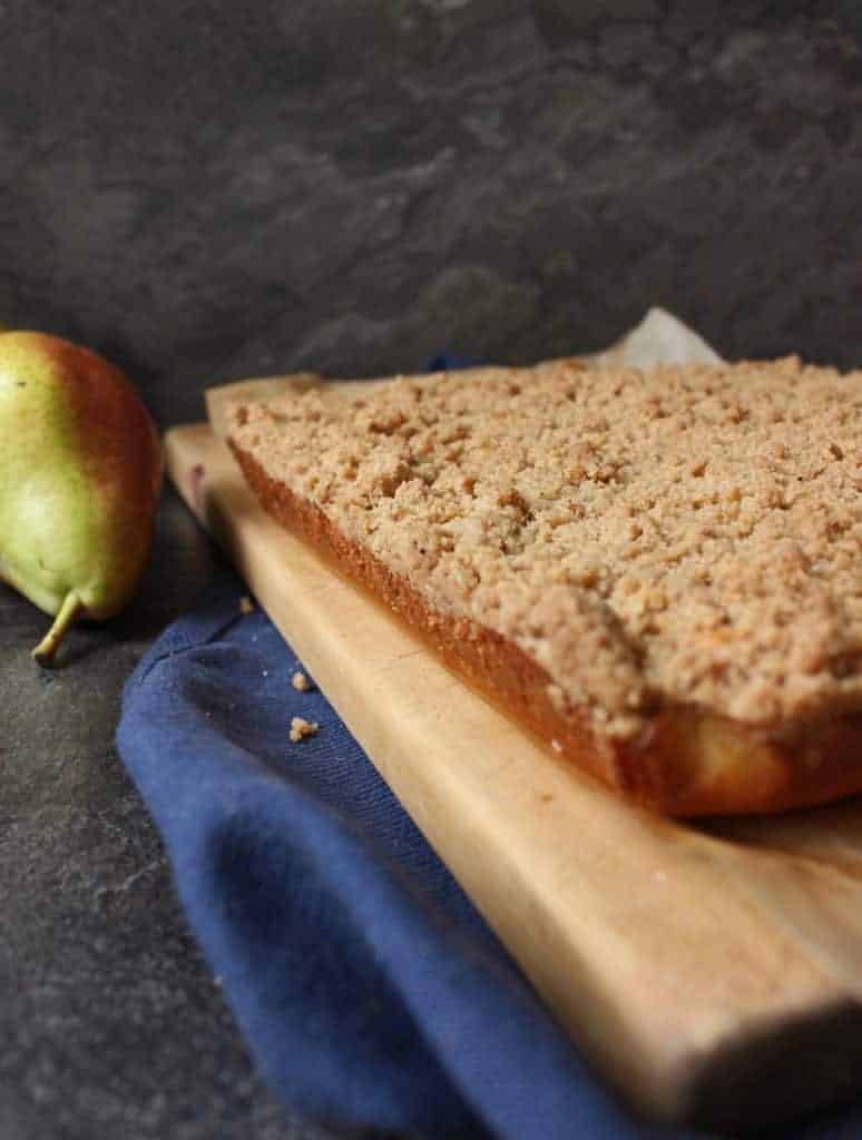 Baked cake on a wooden cutting board.