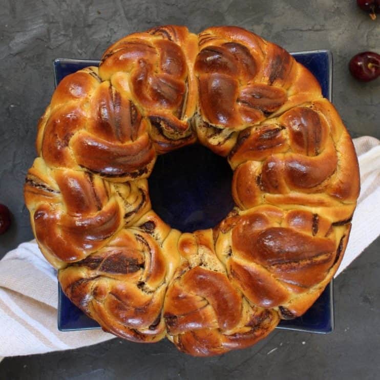 Sweet bread from above on a square cake stand with a white napkin