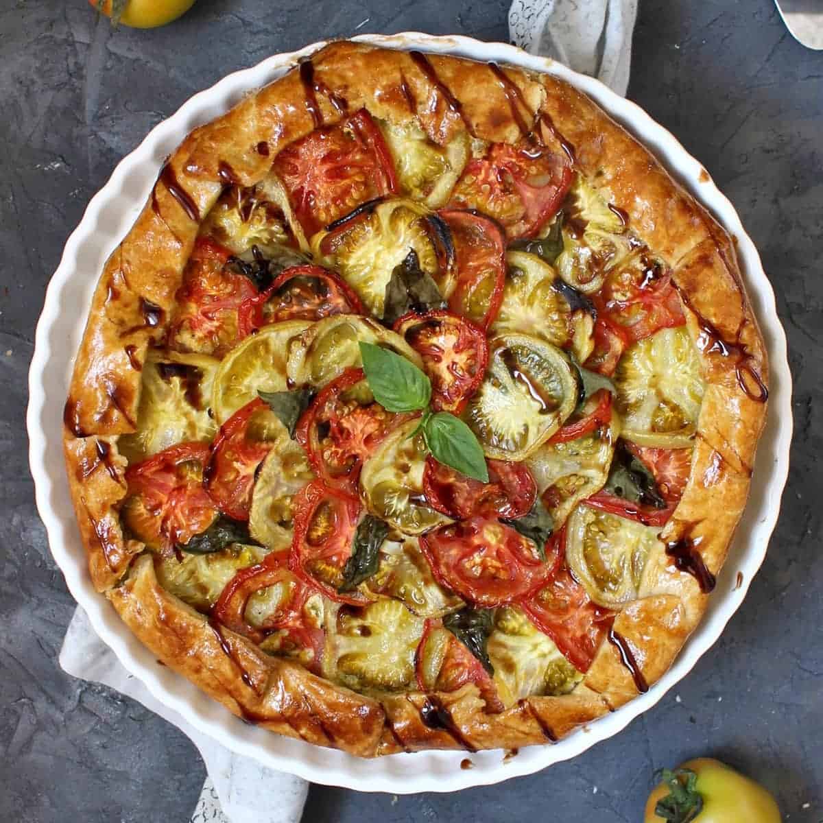 Tomato galette from above on a white stand