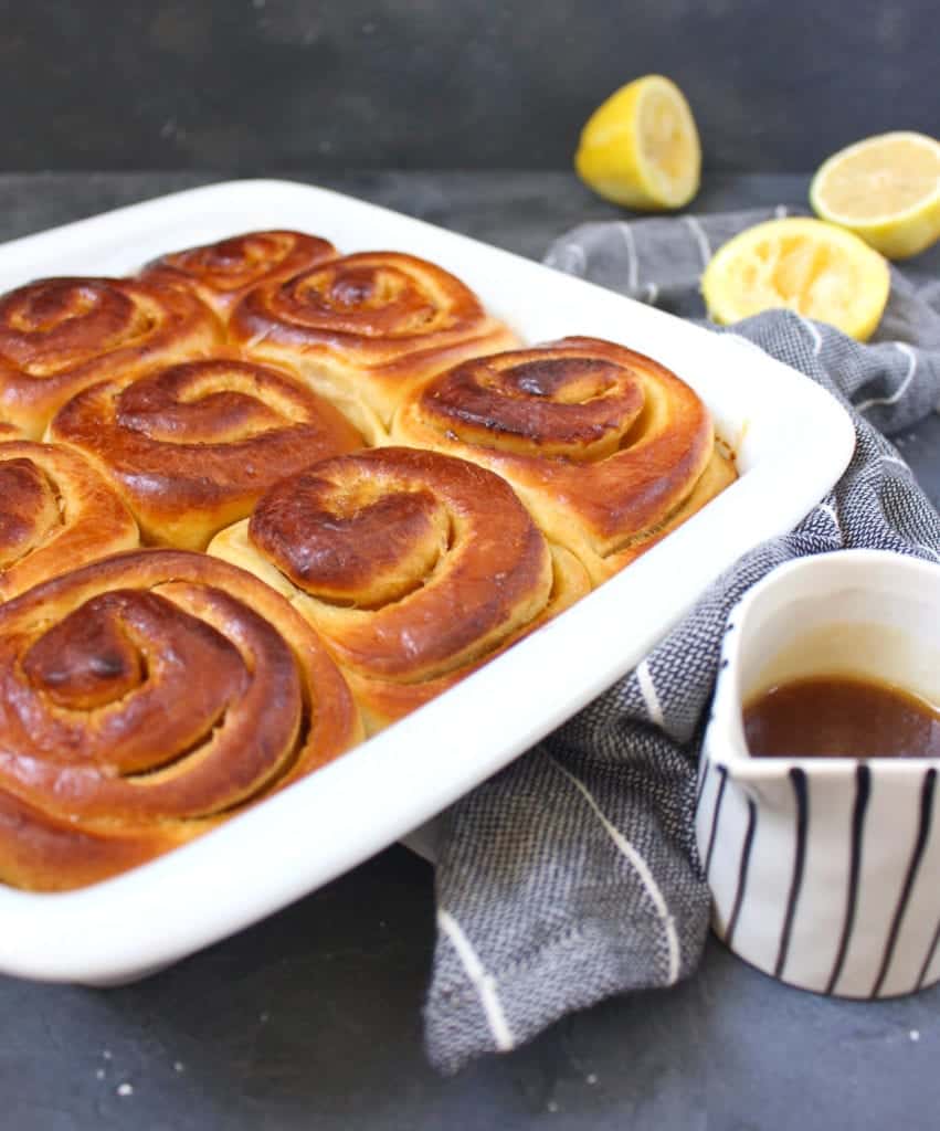 Baked buns in a white ceramic dish.