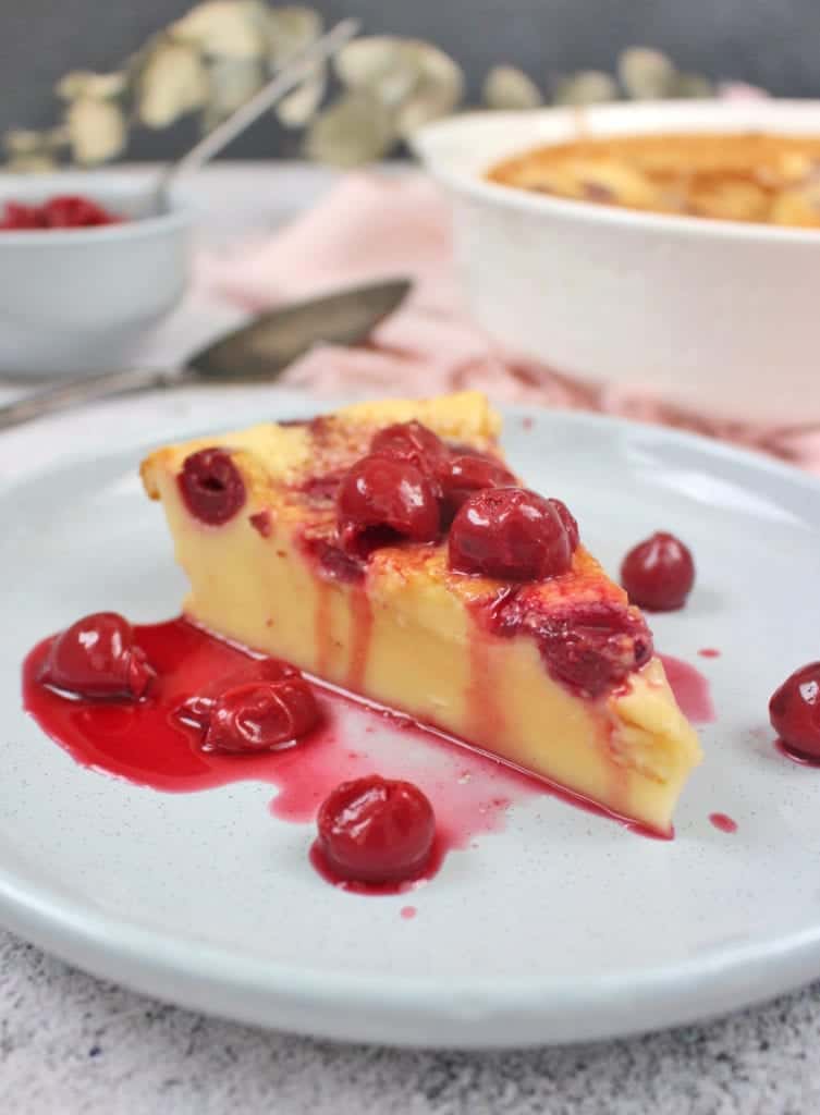 One slice of clafoutis topped with morello cherries