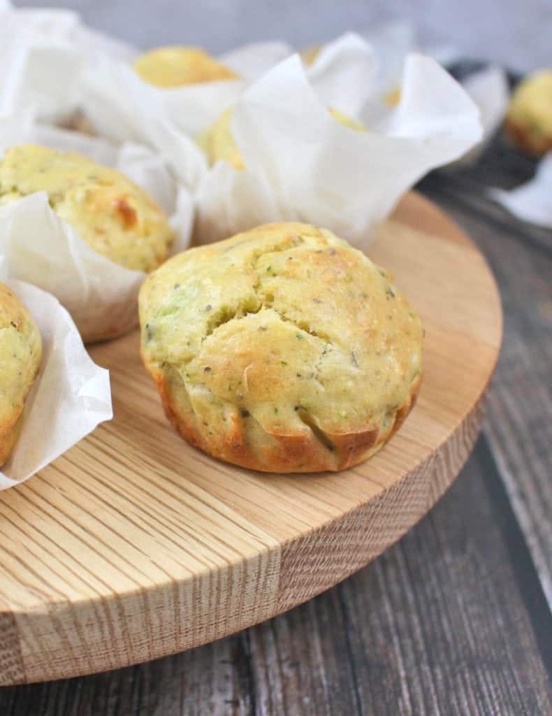 One muffin on a round wooden cake stand.