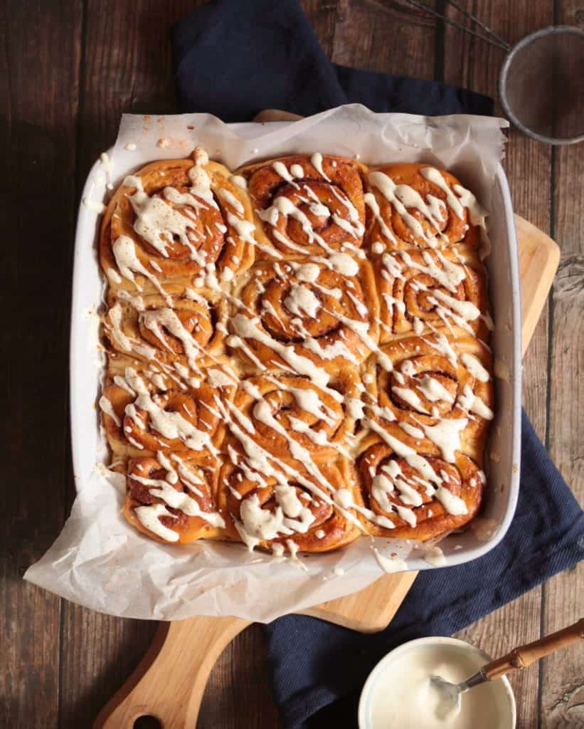 Scrolls in the baking pan from above topped with Yogurt Icing