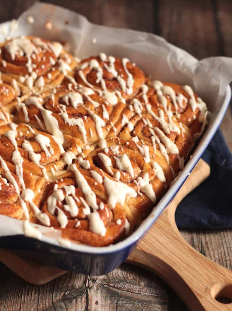 Side view on the breads in the baking dish with the icing drizzle