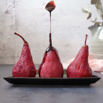 Three Poached Pears on a plate with Poached Syrup