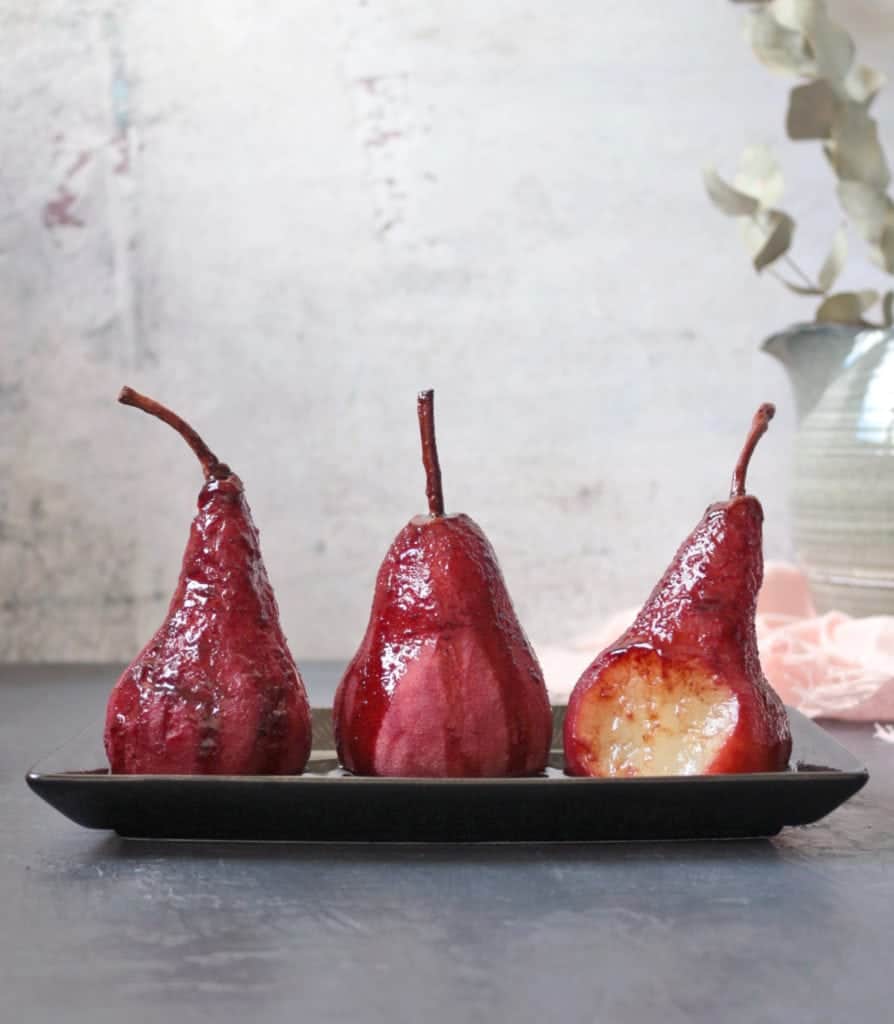 3 Pears poached with red wine reduction poured over