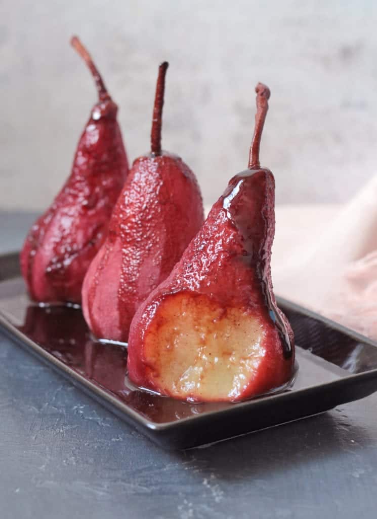 Close up on a poached pear with a bite taken off