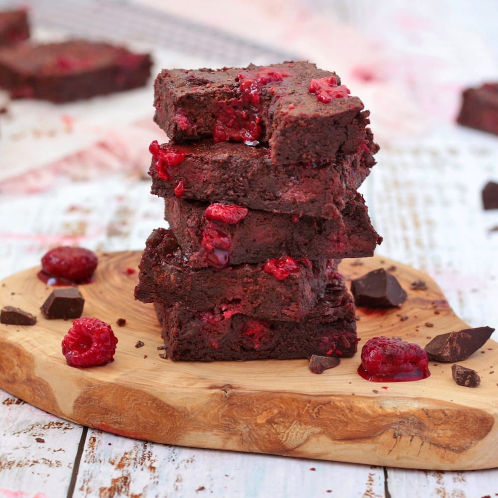 Stack of Raspberry Brownies on a wooden board