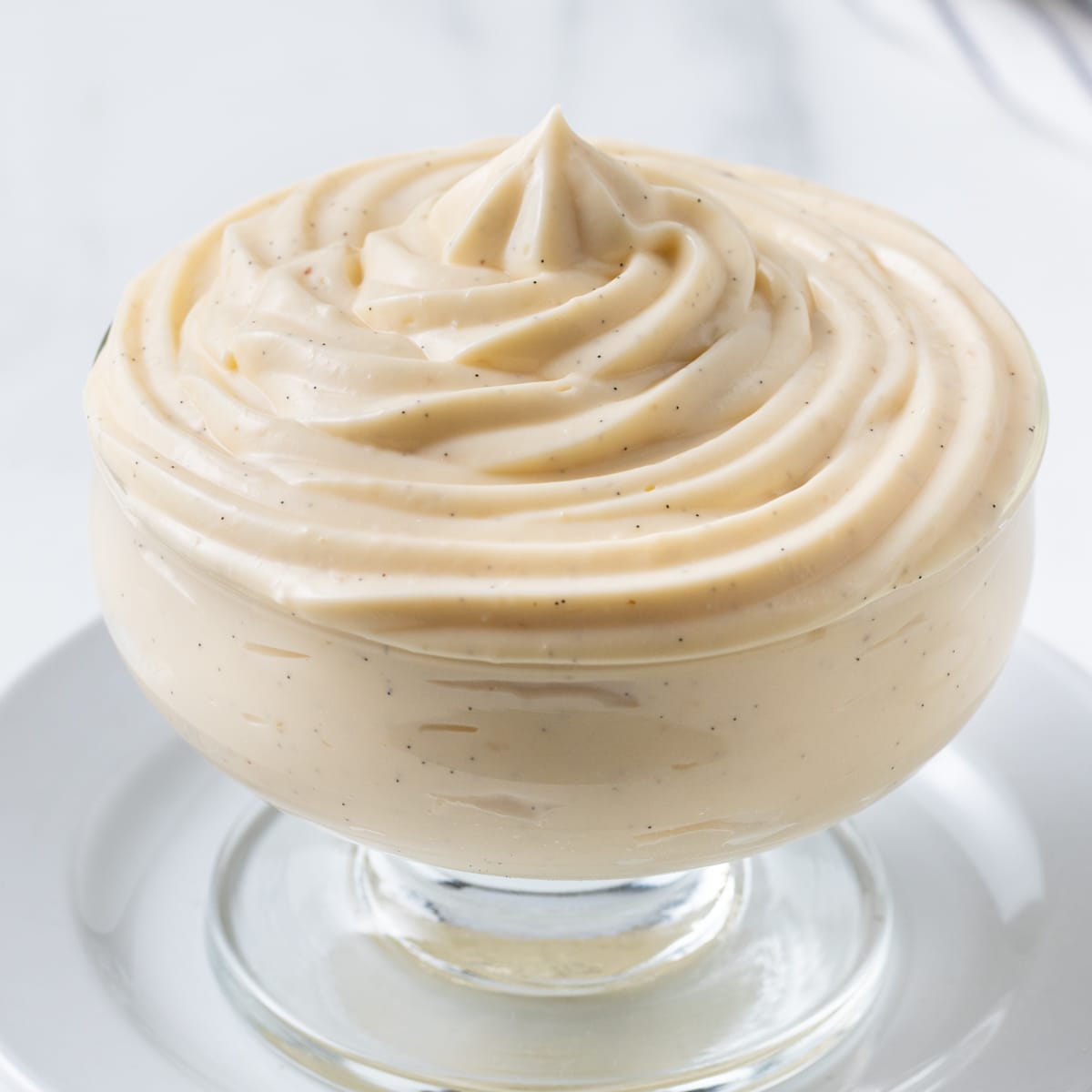 Close up on the pastry cream piped in a glass cup.