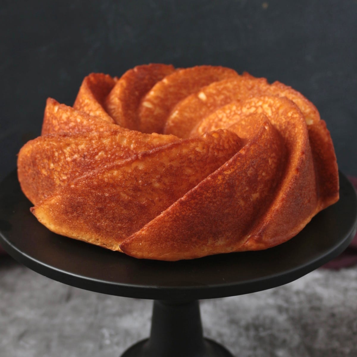 Lemon Yogurt Cake on a cake stand