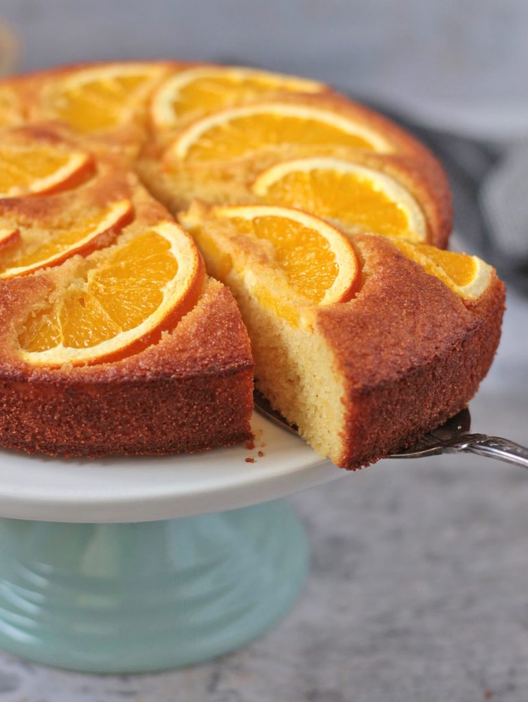 Cutting off a slice of semolina almond cake