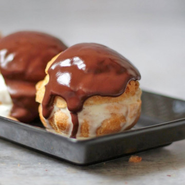 Zoom on one choux covered with warm chocolate sauce