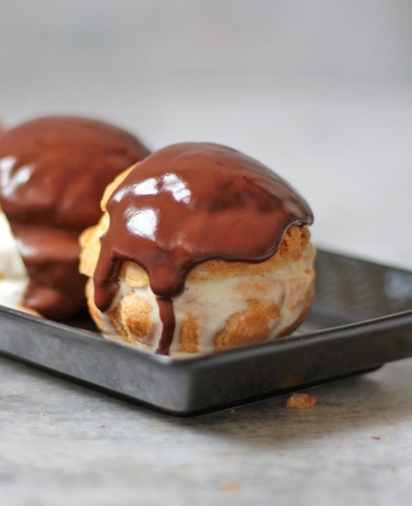 Close-up on a Profiteroles over a black plate