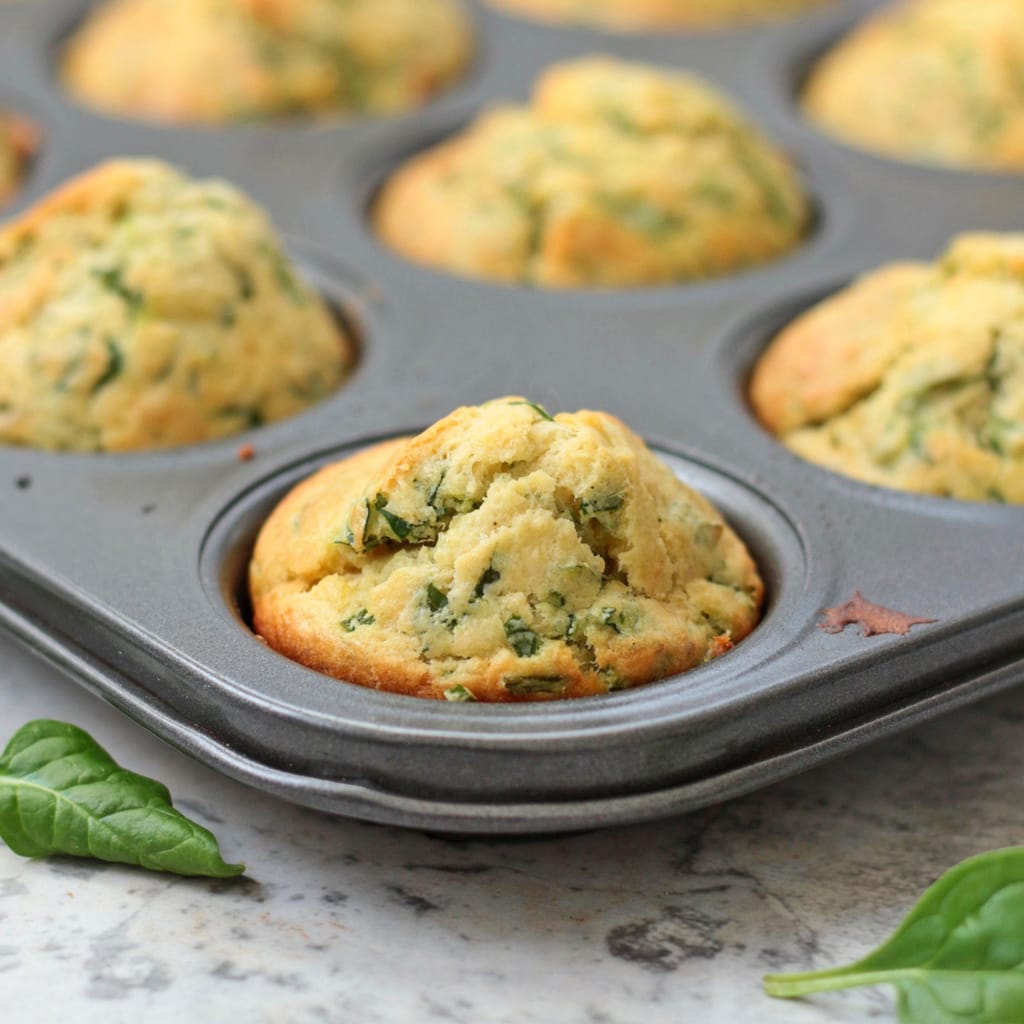 Close up on a Cheddar and Spinach Muffin in the muffin pan.