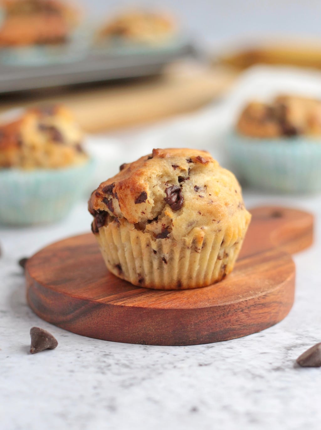 One Muffin over a small wooden board without its wrapper