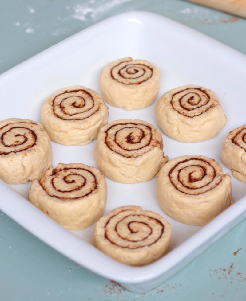Unbaked rolls in a white ceramic dish
