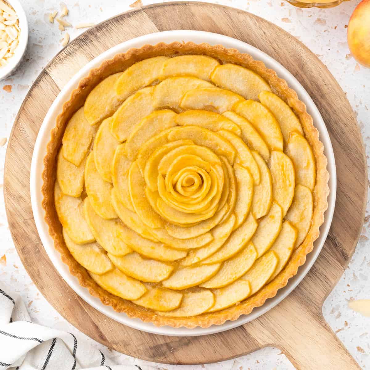 Tart on a round wooden board seen from above.