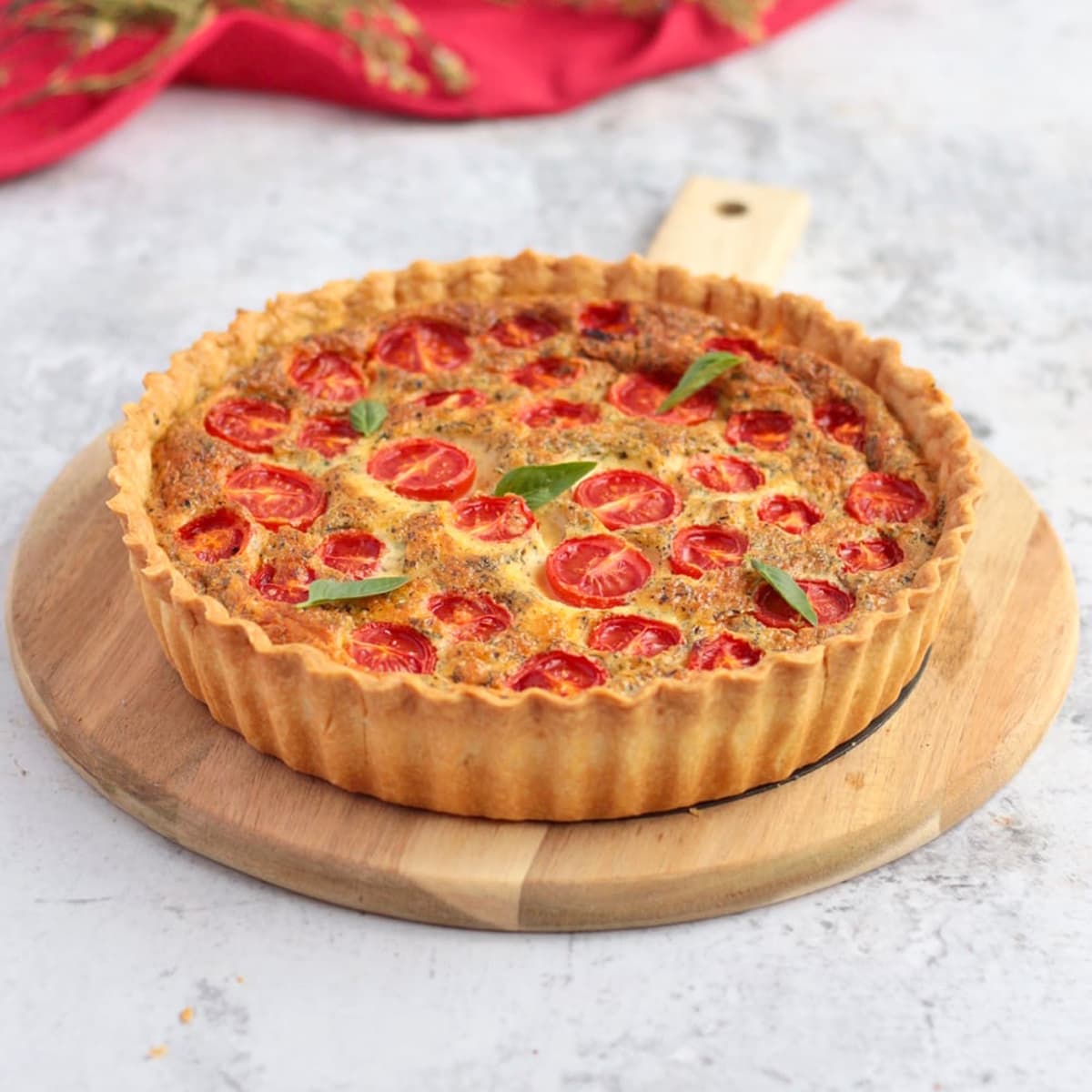 Cheese Quiche with Tomato on a serving board
