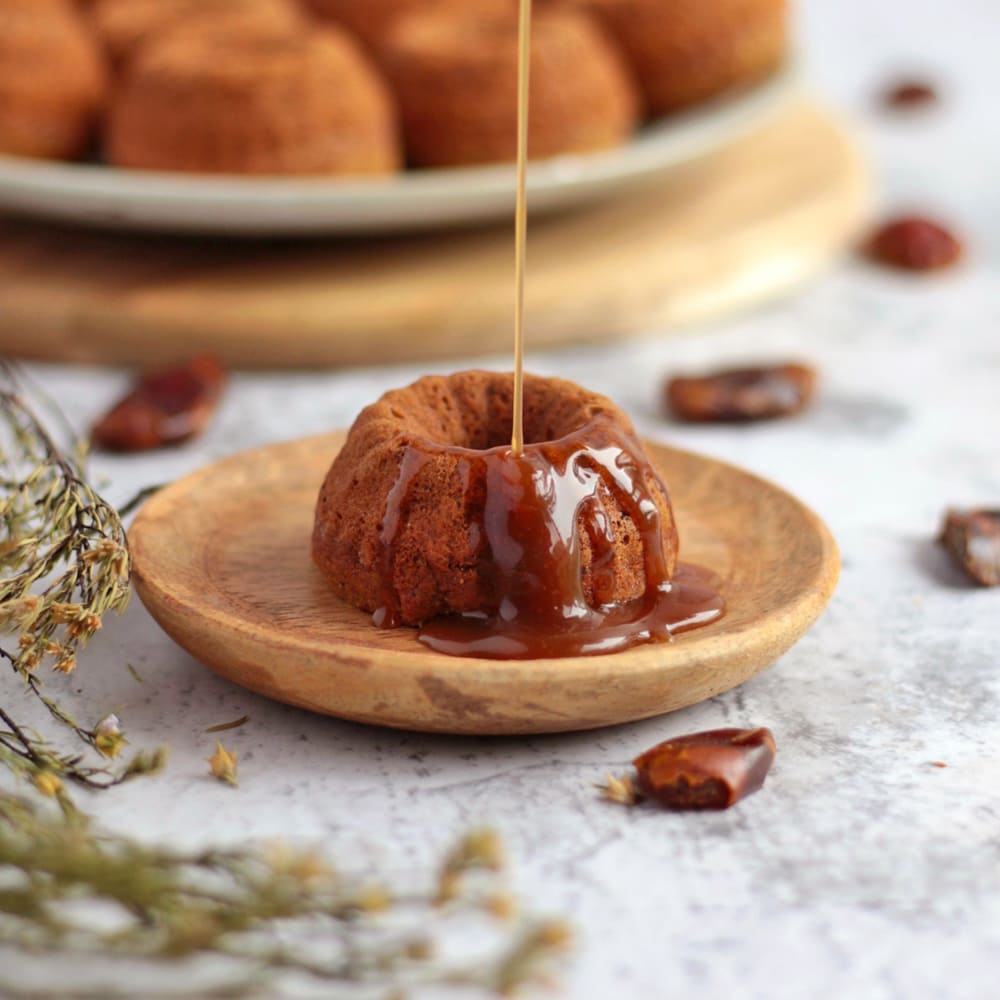 Caramel Sauce poured over a Vegan Sticky date Pudding.