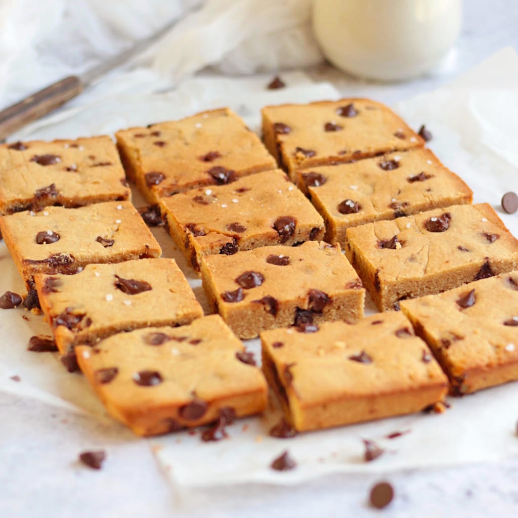 Sliced Chocolate Chip Blondie Bars on baking paper.