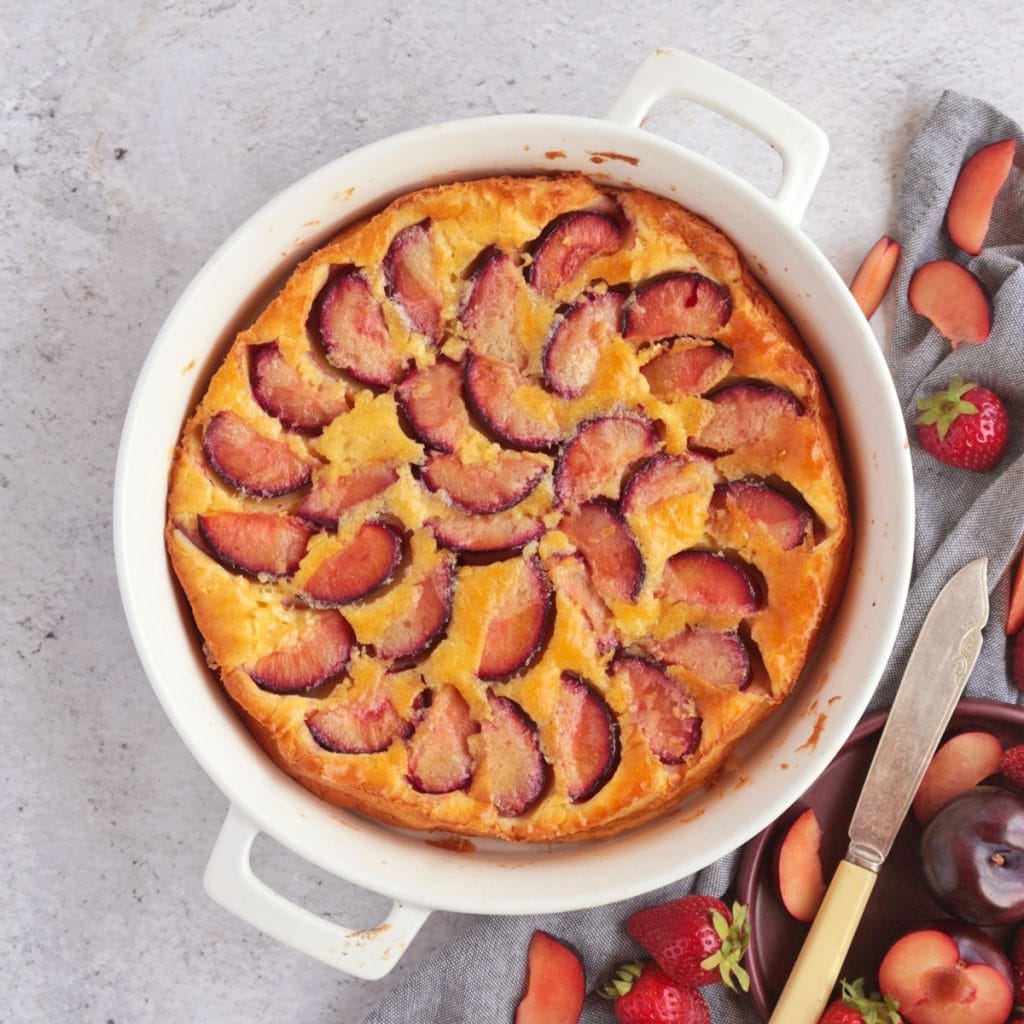 Plum Clafoutis from above in a white ceramic dish