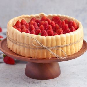 Strawberry Charlotte Cake on a wooden Cake stand