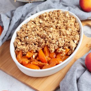 Placing the oat crumble over the fresh apricots