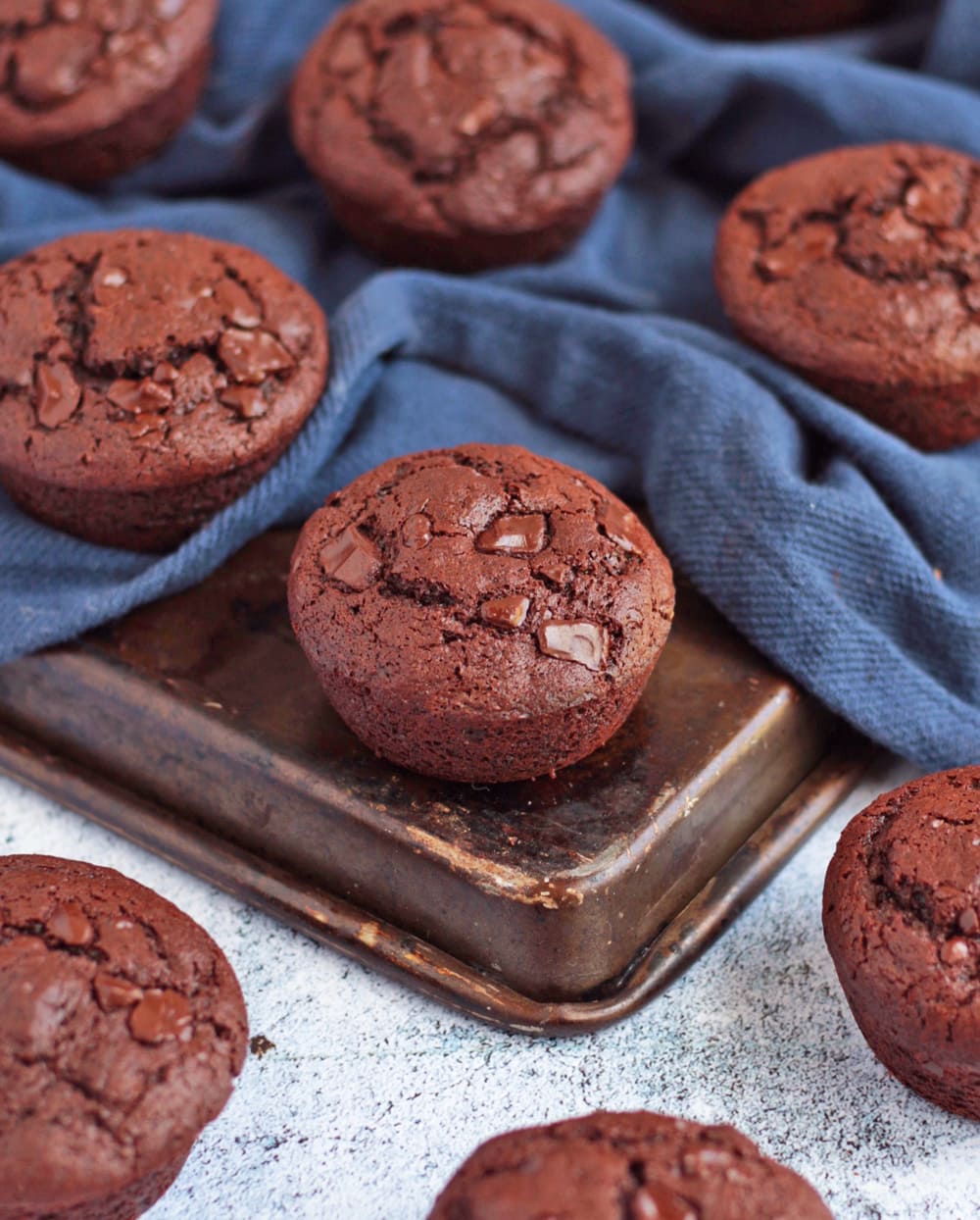 Close up on a muffin surrounded by a blue napkin.