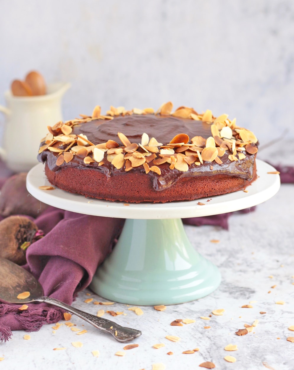 Chocolate Cake on a Cake Stand with chocolate ganache and toasted almond flakes