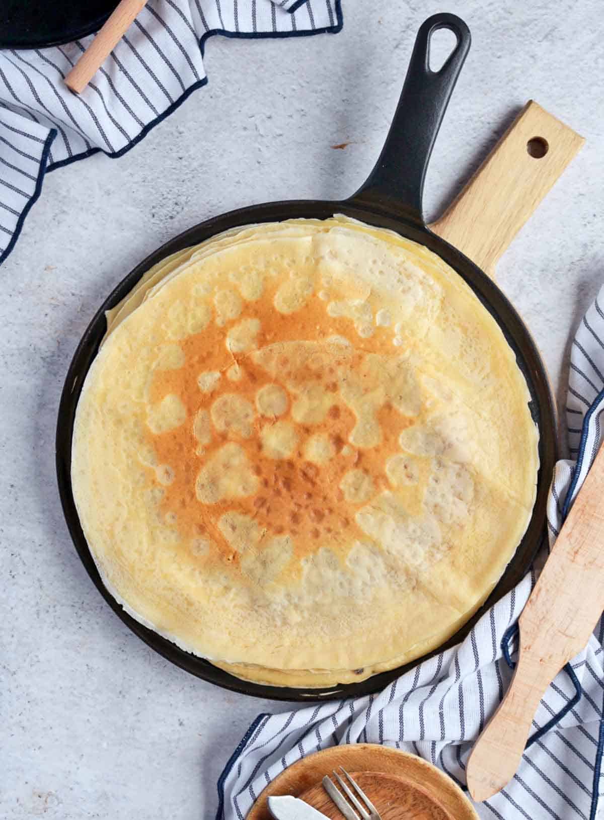 Cooked crepes from above in a pan.