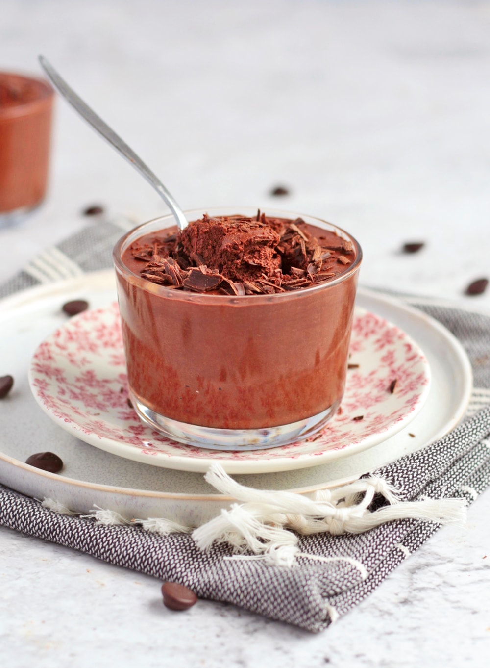 Mousse in a cup with a spoon.