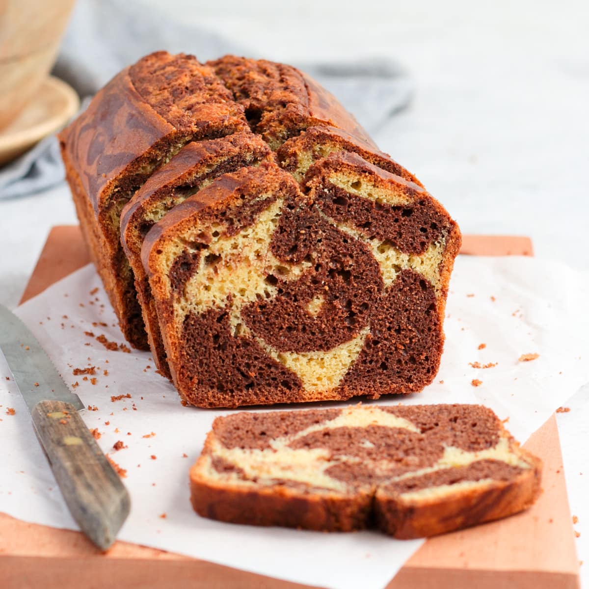 Cake on a wooden board with one slice down