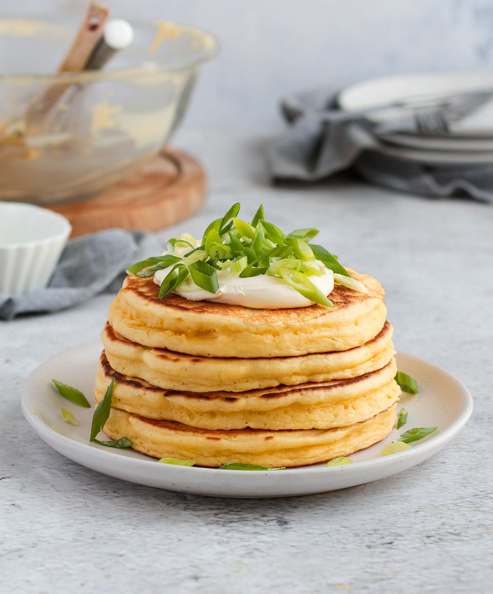 Stack of 4 pancakes on a white plate.