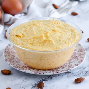 Almond Cream in a small Glass Bowl over a pink plate