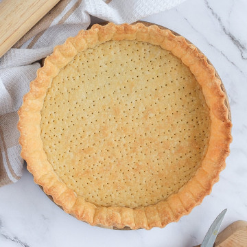 Blind-baked pastry from above on a marble surface