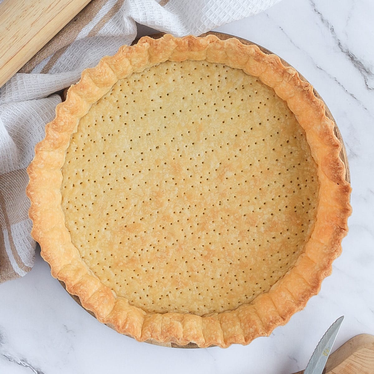 Blind-baked pastry from above on a marble surface