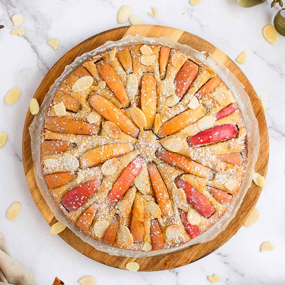 Apple Cake from above sitting on a wooden round board.