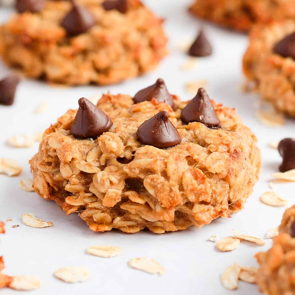 Close up on one peanut butter banana oatmeal cookie topped with chocolate chips.