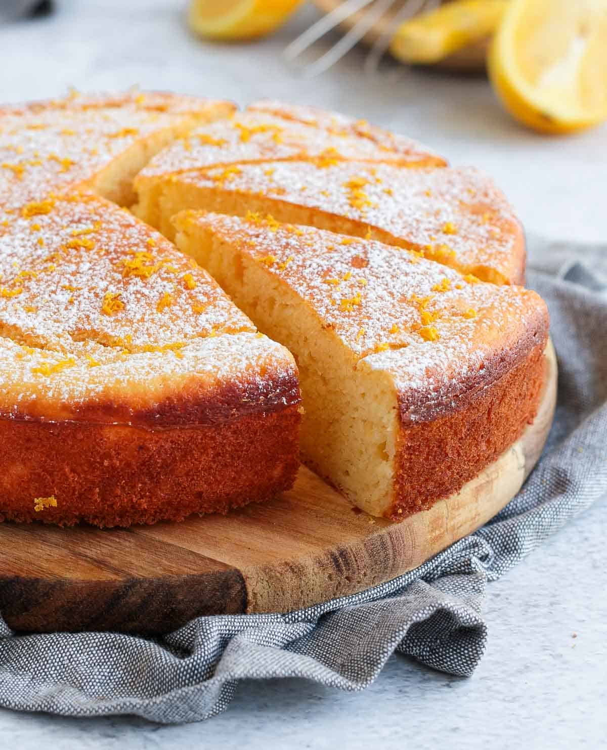 Ricotta Cake sliced over a wooden board.