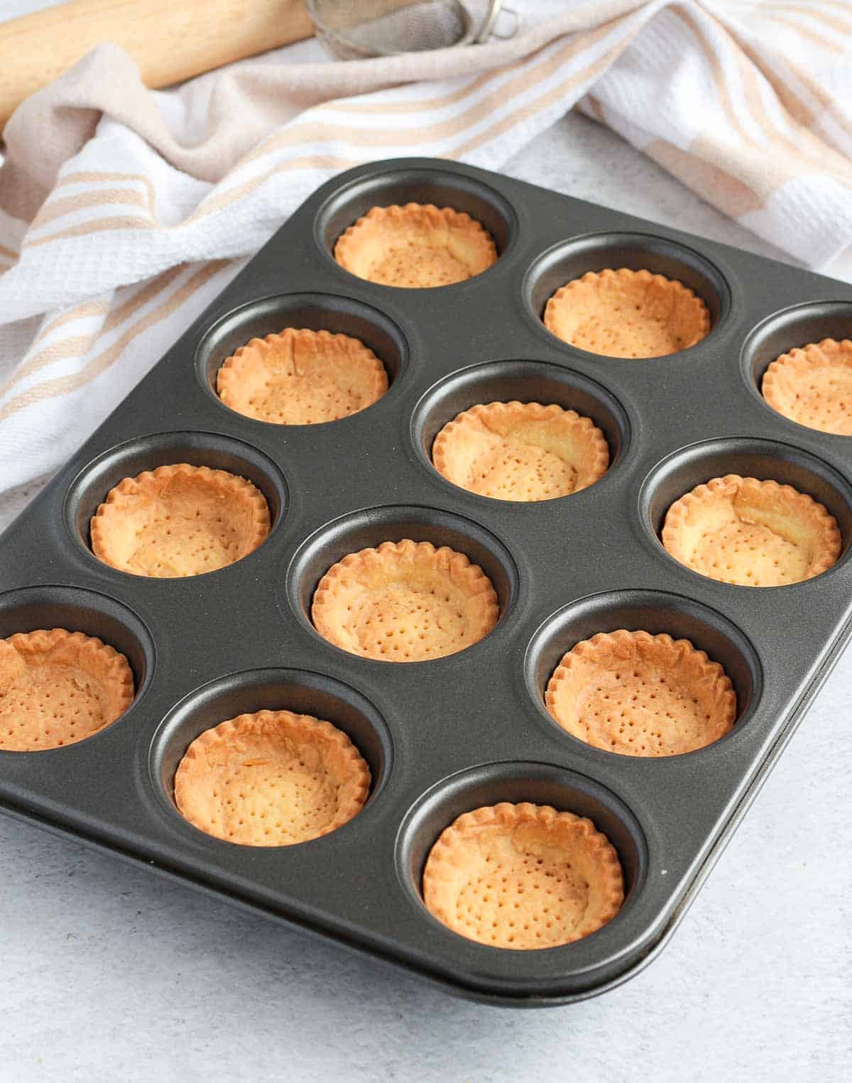 Baked tartlet crusts in the muffin pan.