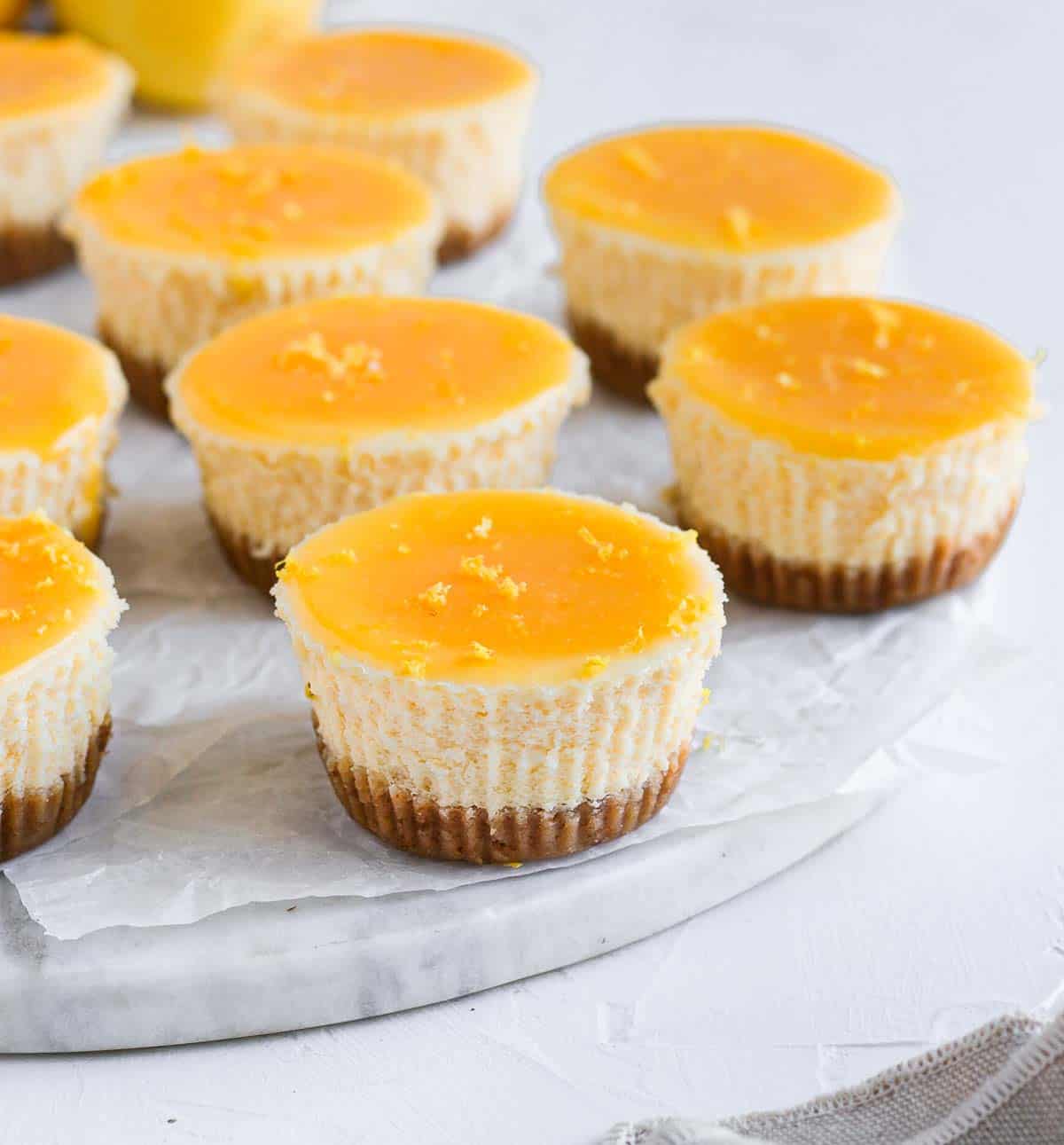 Lemon Cheesecake on a round marble board.