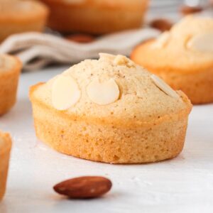 Close up on one almond cake over a white surface.