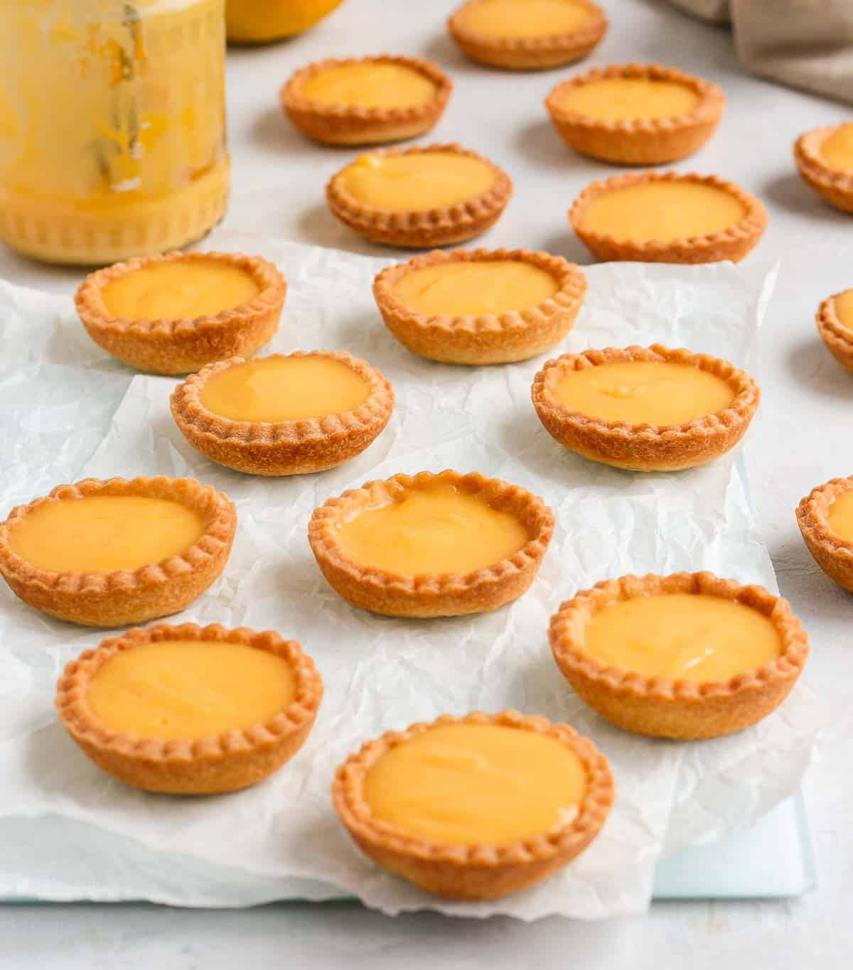 Mini Tarts on a glass serving board.