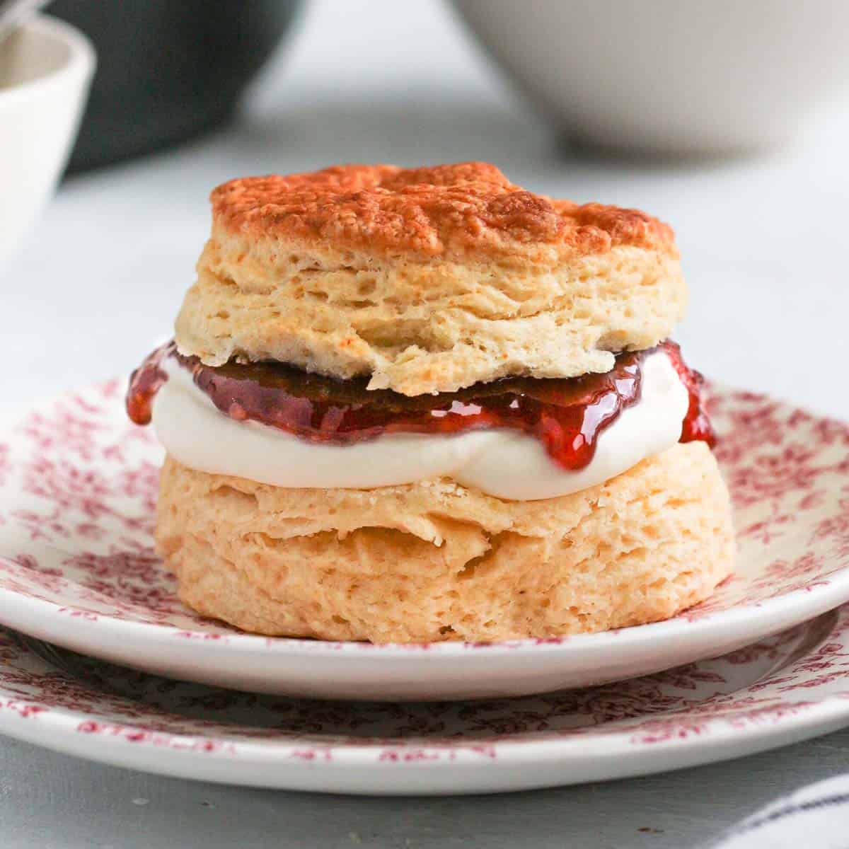 Close up on a filled scones on a pink plate.