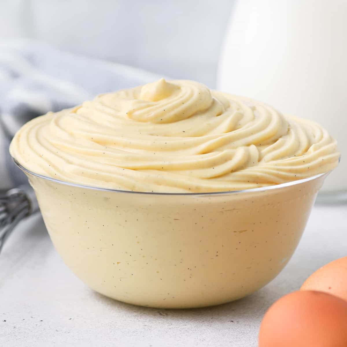 Diplomat Cream in a glass bowl surrounded by ingredients.