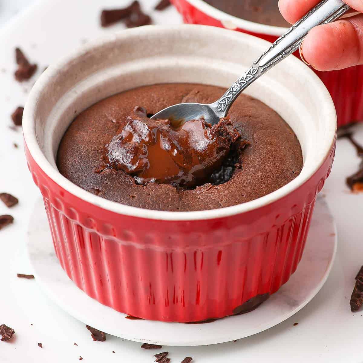Dipping a spoon in a warm chocolate fondant cake.