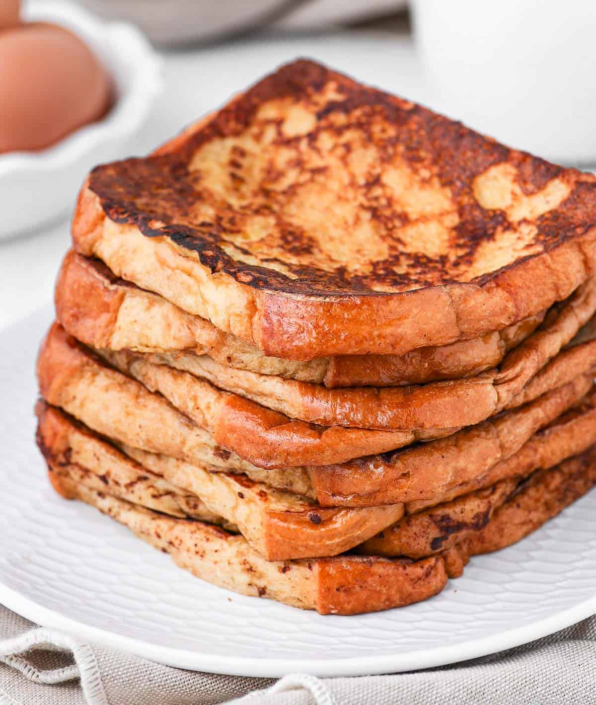Stack of french toast on a white plate.